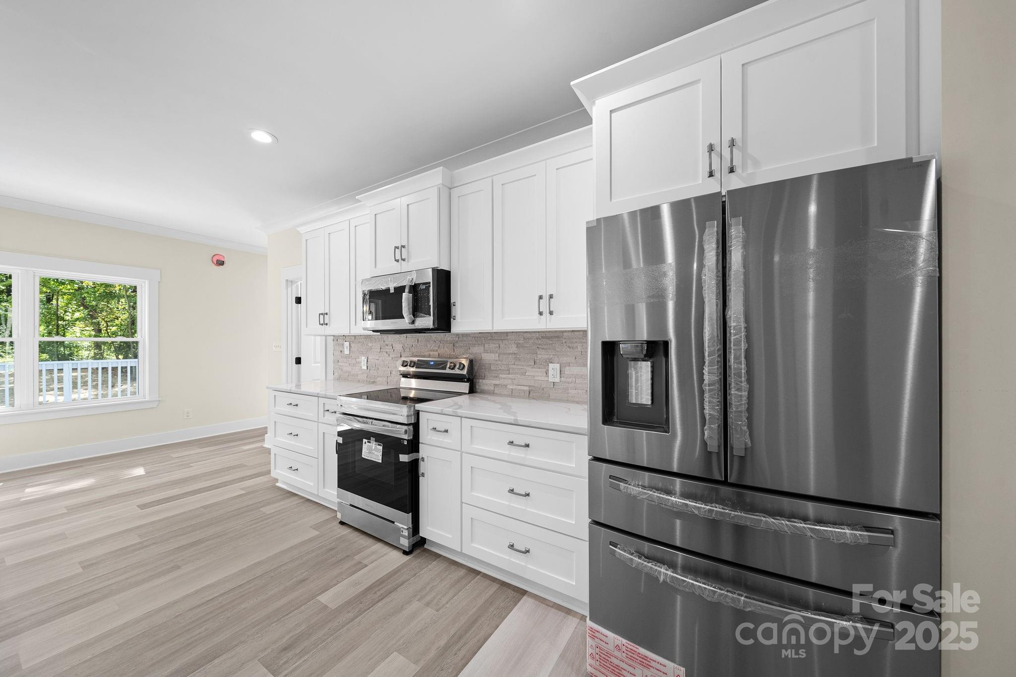 4460 R R L Lane Midland, NC 28107 - Photo 20 of 48 a kitchen with stainless steel appliances a refrigerator sink and microwave