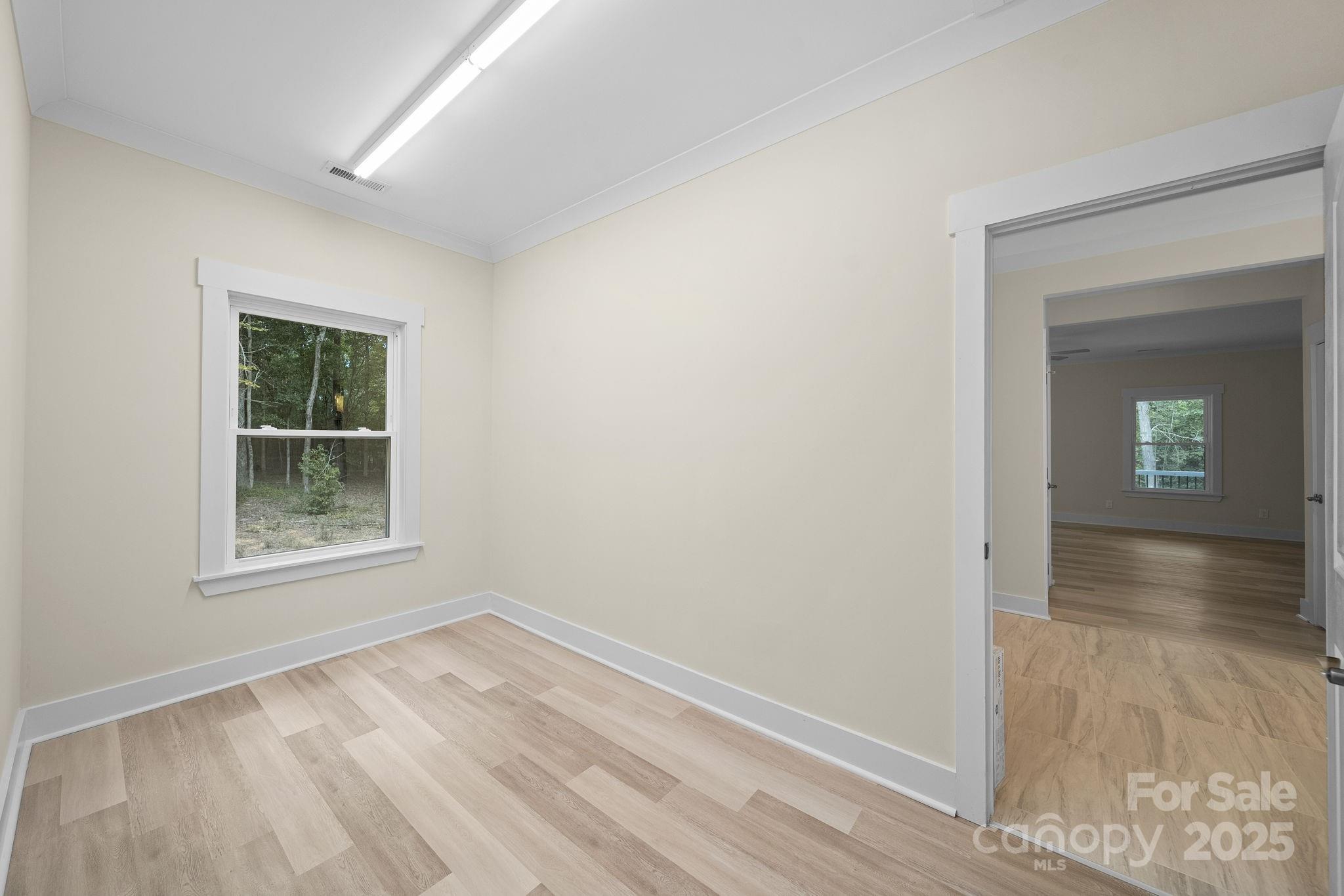 4460 R R L Lane Midland, NC 28107 - Photo 30 of 48 an empty room with a window and wooden floor