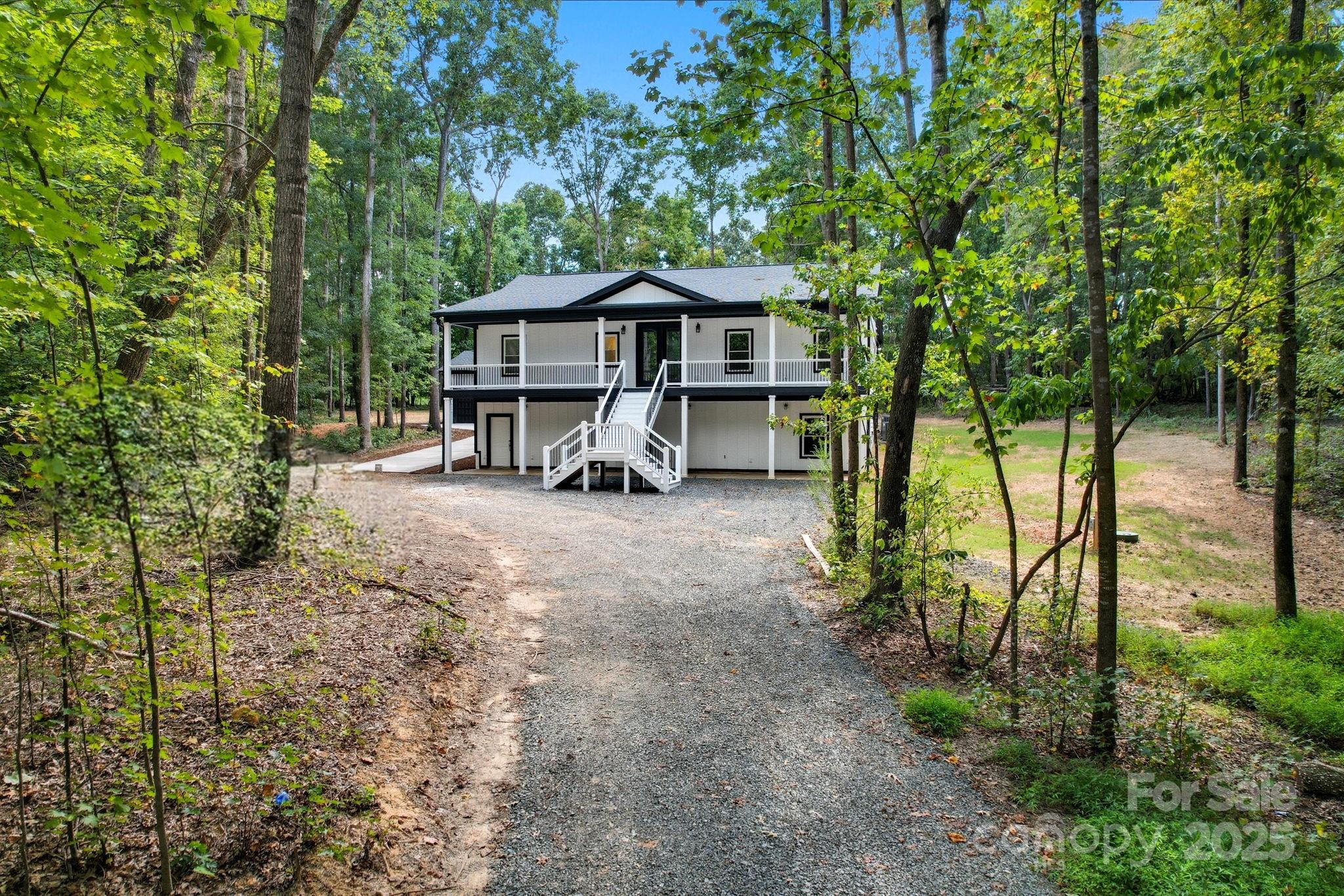 4460 R R L Lane Midland, NC 28107 - Photo 3 of 48 a view of a house with large trees and sitting area