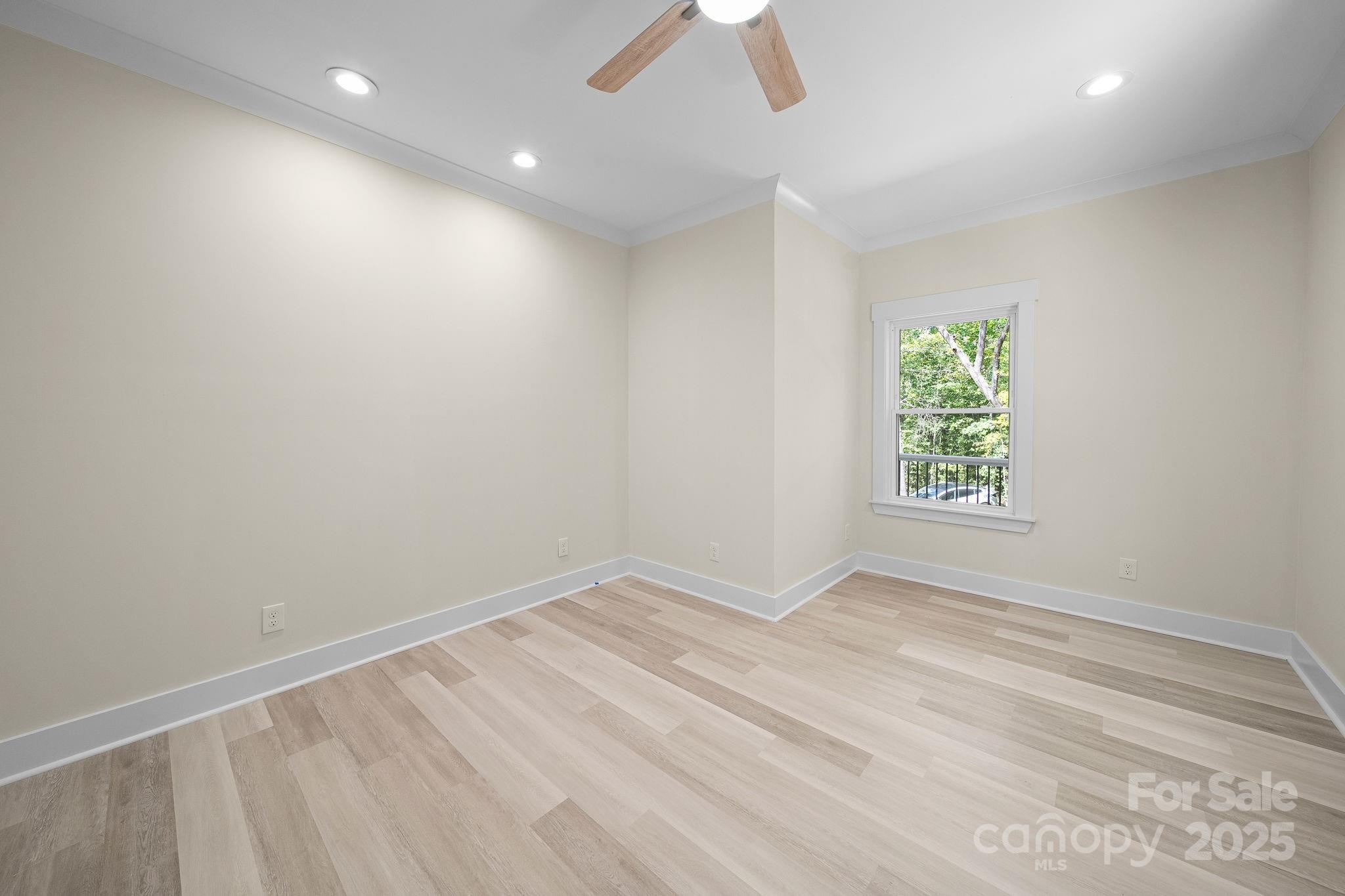 4460 R R L Lane Midland, NC 28107 - Photo 31 of 48 an empty room with a window and a ceiling fan