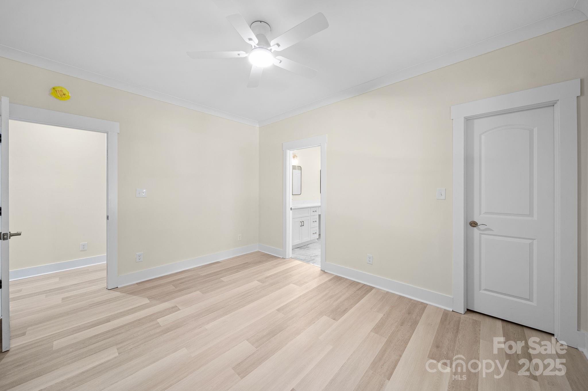 4460 R R L Lane Midland, NC 28107 - Photo 38 of 48 a view of an empty room with wooden floor and a ceiling fan