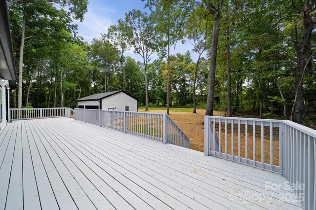 a view of a wooden deck and trees