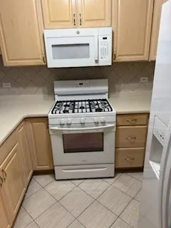 a stove top oven sitting inside of a kitchen