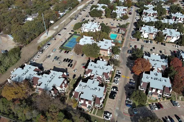 an aerial view of multiple houses with outdoor space