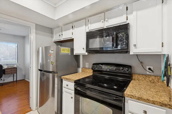 a kitchen with stainless steel appliances granite countertop a stove and a refrigerator