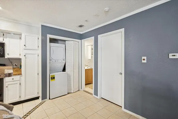 a view of a kitchen with white cabinets and refrigerator