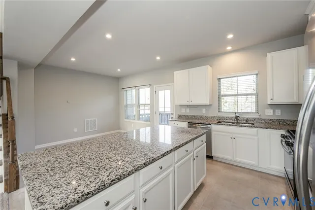 a kitchen with granite countertop a sink and a window