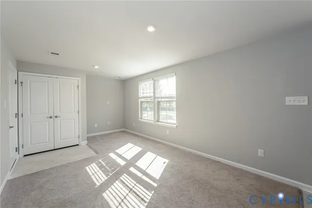 a view of an empty room and a window