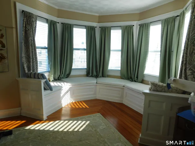 a living room with furniture and large windows