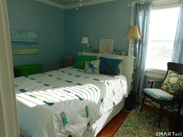 a bed sitting in a bedroom next to a window