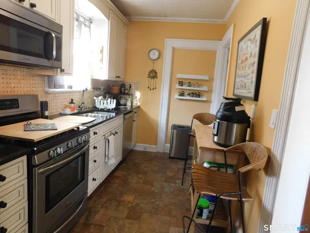 a kitchen with a sink stove and microwave