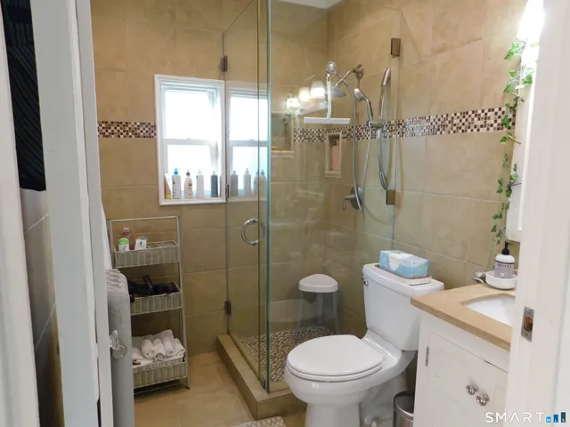 a bathroom with a toilet and a shower