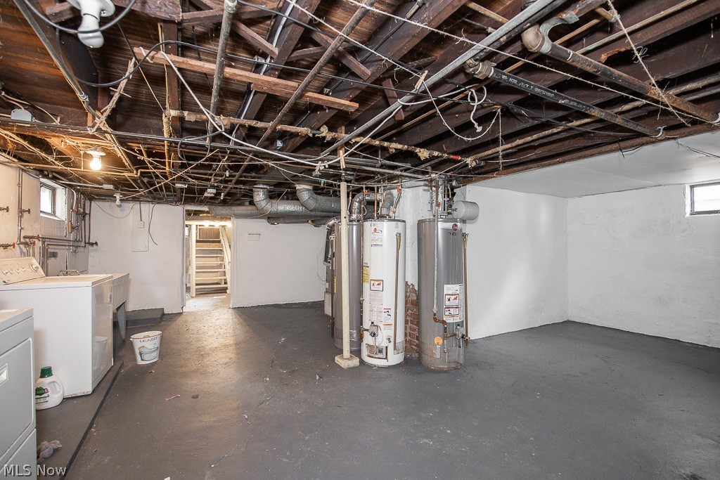 1405 Sheffield Road Cleveland, OH 44121 - Photo 22 of 29 Basement with washer and clothes dryer, a wealth of natural light, and gas water heater