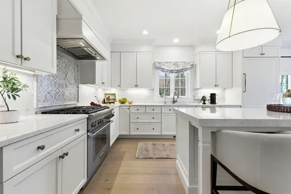 a kitchen with granite countertop a sink stainless steel appliances and cabinets