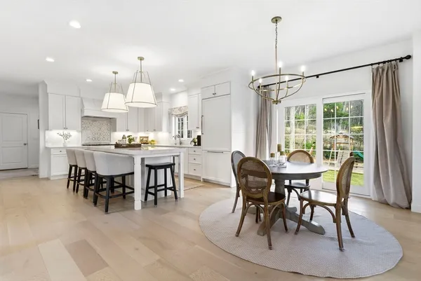 a dining room with furniture a rug and a chandelier