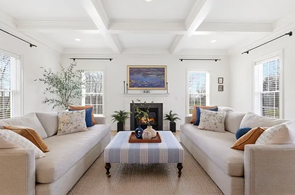 a living room with furniture large window and a fireplace