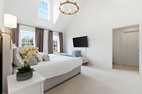 a bedroom with bed and glass door