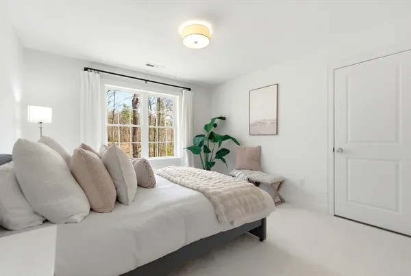 a bedroom with bed and a window