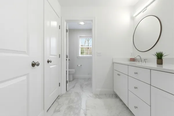 a bathroom with a double vanity sink and a mirror