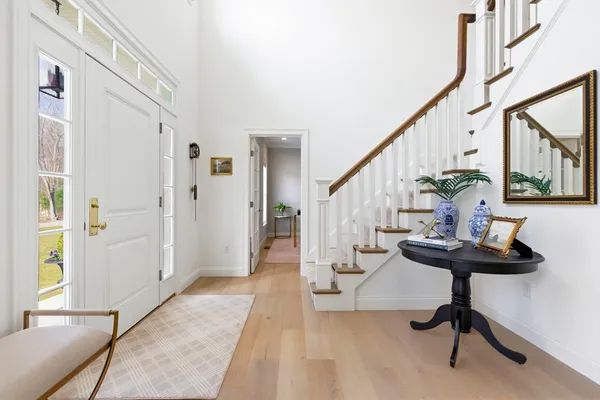 a view of entryway with wooden floor and stairs