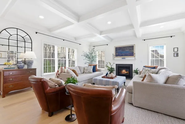 a living room with furniture a fireplace and a large window