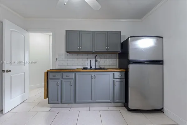 a kitchen with stainless steel appliances granite countertop a refrigerator and a sink