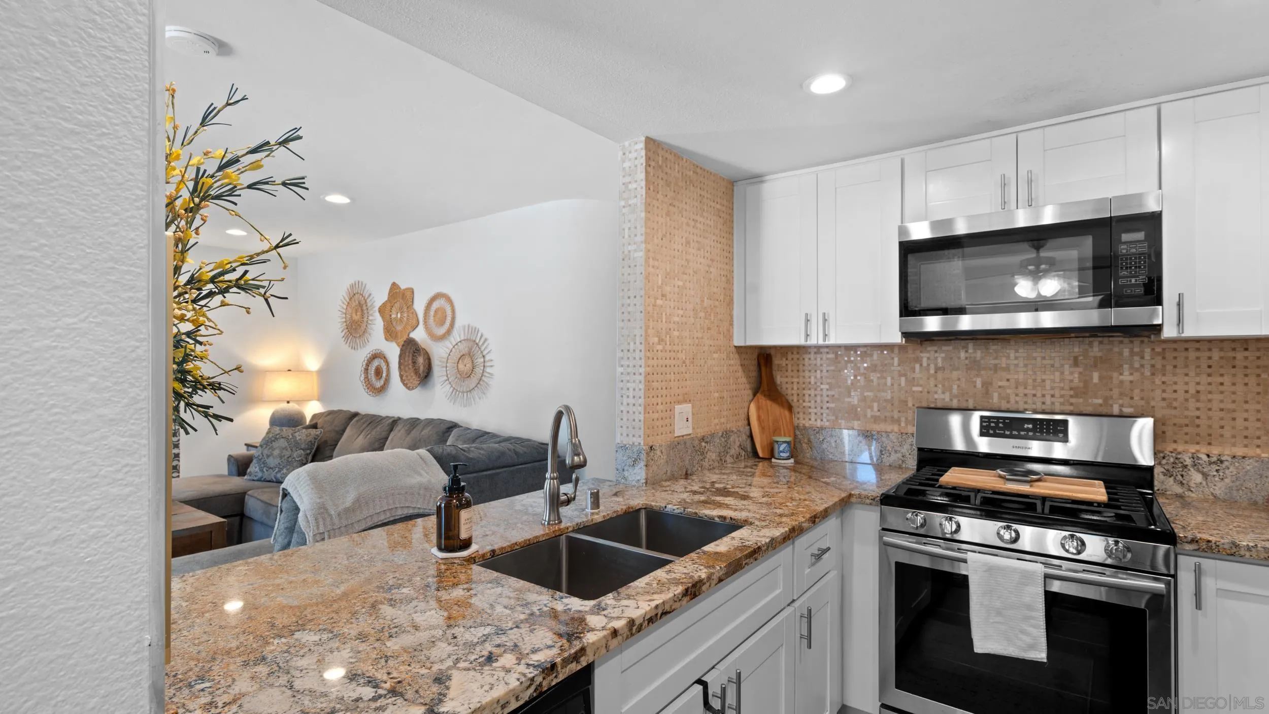 725 Brookstone Road, Unit 101 Chula Vista, CA 91913 - Photo 7 of 31 a kitchen with stainless steel appliances granite countertop a sink a stove and a microwave