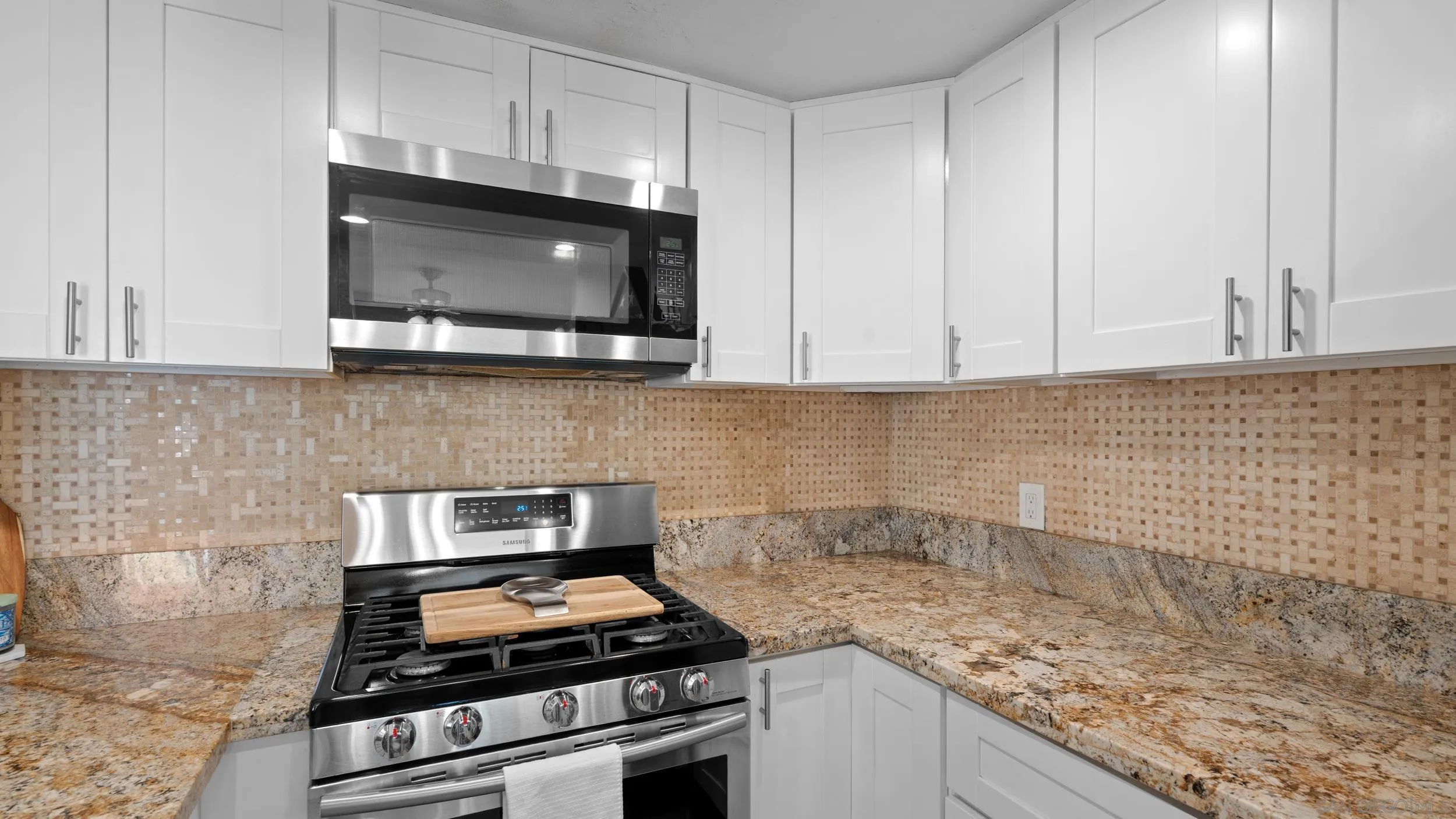 725 Brookstone Road, Unit 101 Chula Vista, CA 91913 - Photo 8 of 31 a kitchen with granite countertop white cabinets stainless steel appliances and a sink