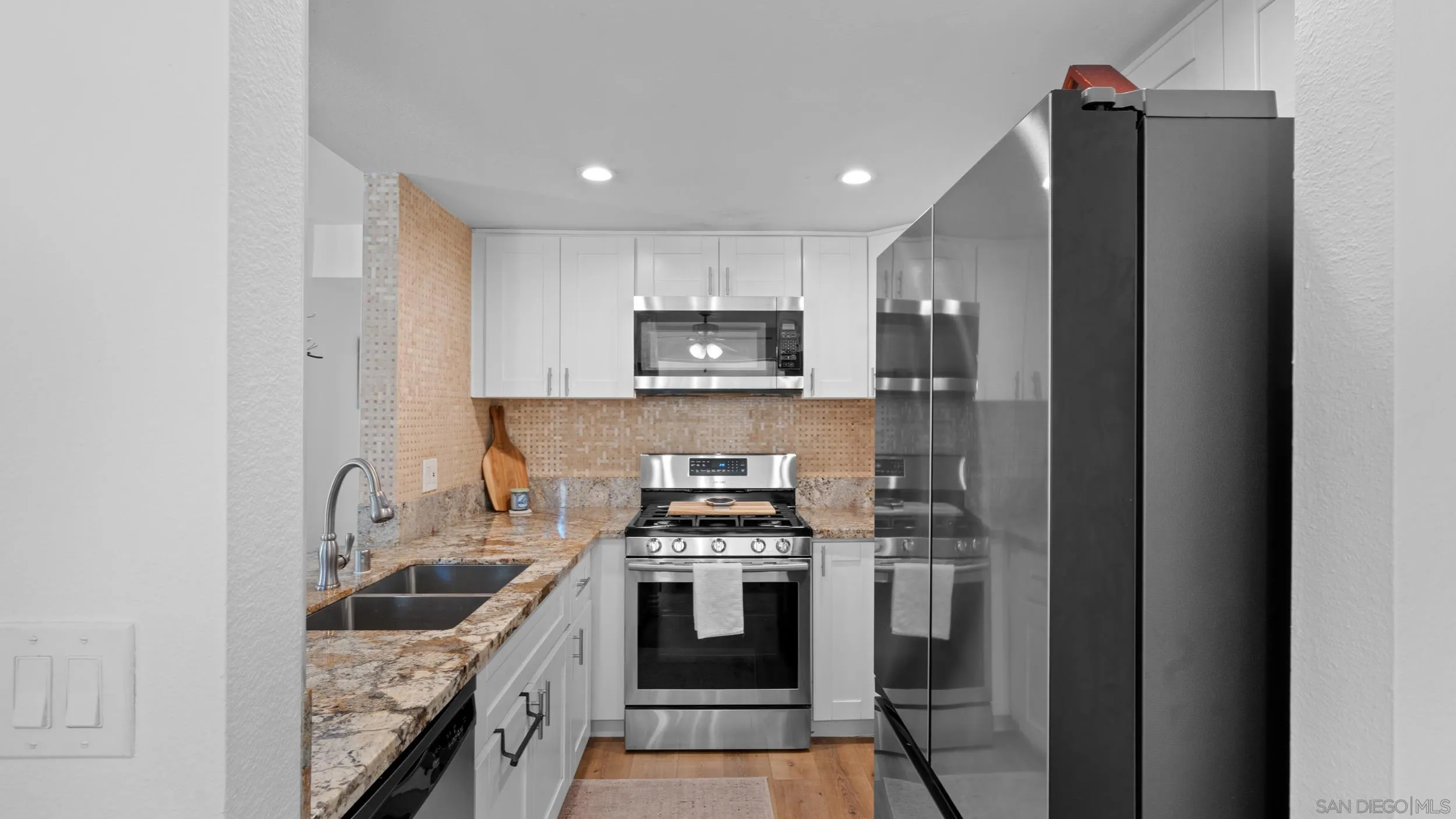 725 Brookstone Road, Unit 101 Chula Vista, CA 91913 - Photo 9 of 31 a kitchen with a sink stove and refrigerator