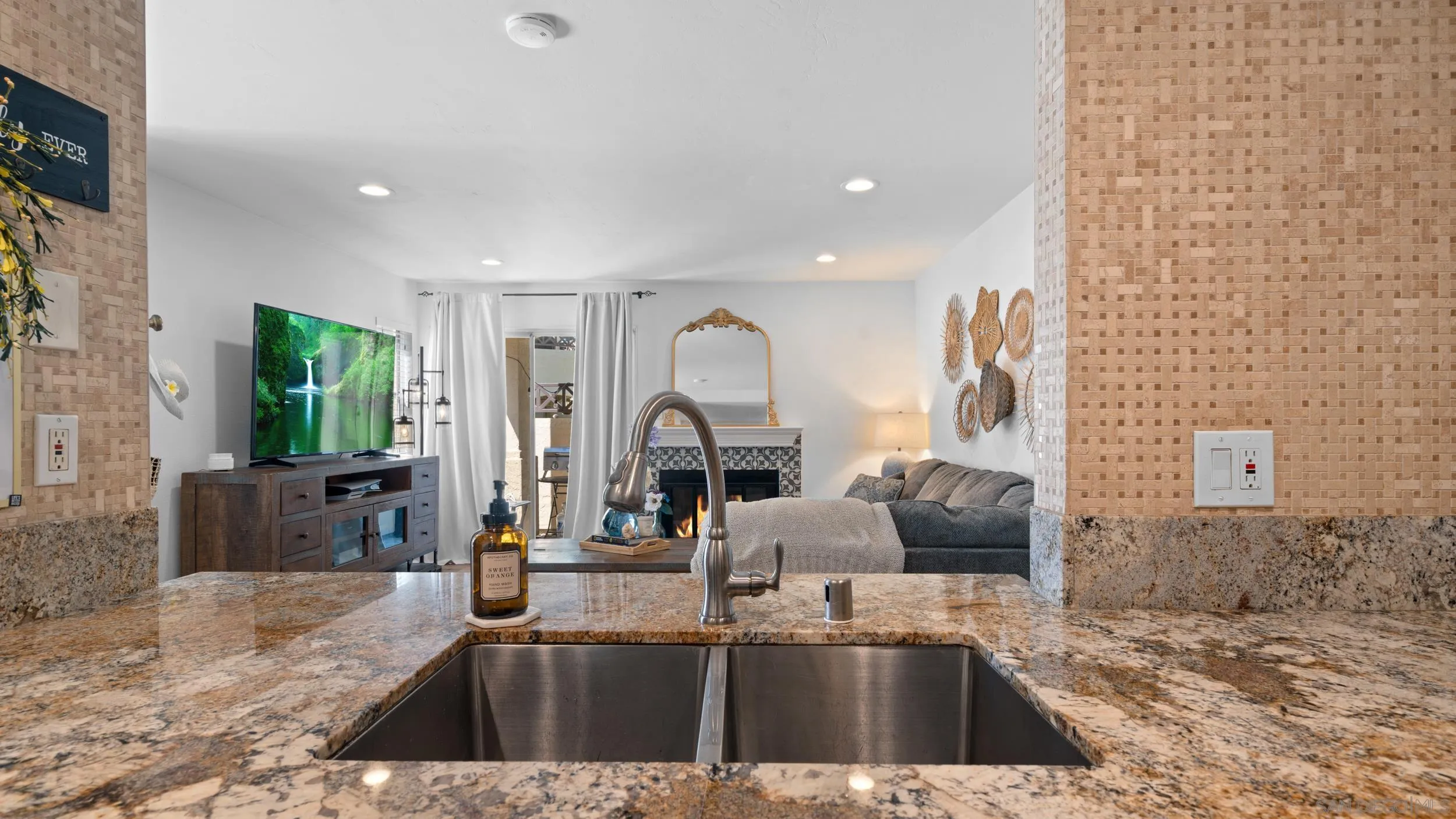 725 Brookstone Road, Unit 101 Chula Vista, CA 91913 - Photo 10 of 31 a kitchen with kitchen island granite countertop a sink and a granite counter tops