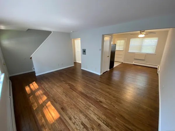 wooden floor in an empty room with a window