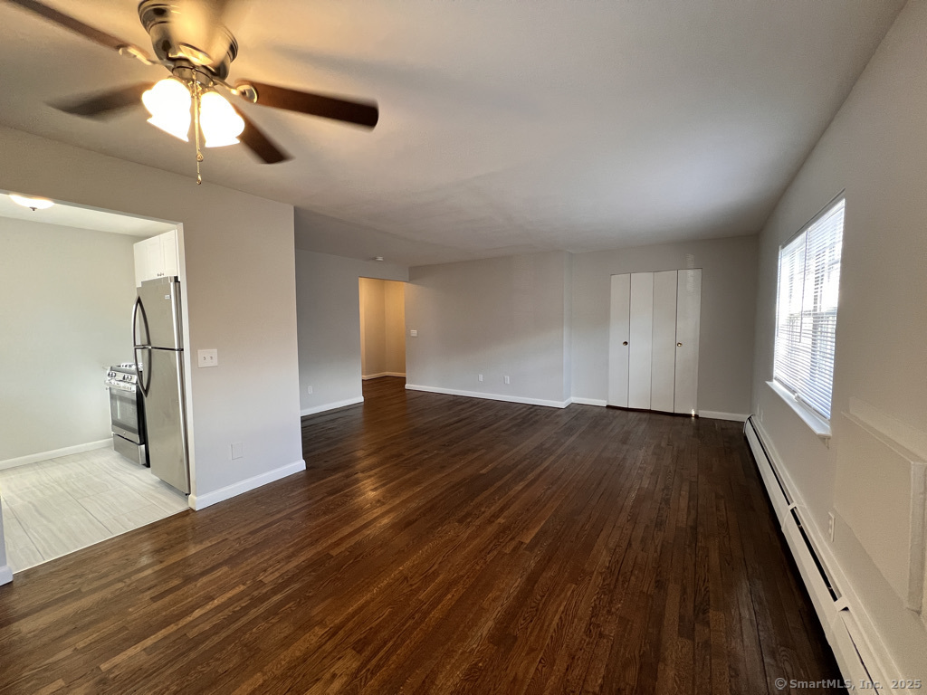 15 Elizabeth Street, Unit 31 West Haven, CT 06516 - Photo 2 of 9 wooden floor in an empty room with a window