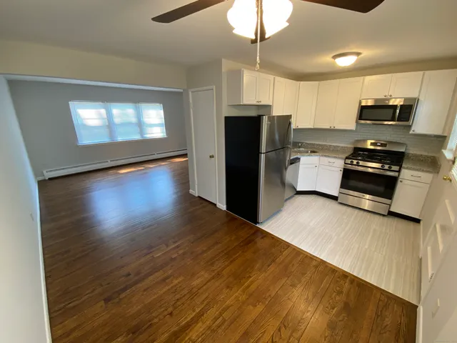 a kitchen with stainless steel appliances a refrigerator stove microwave and cabinets