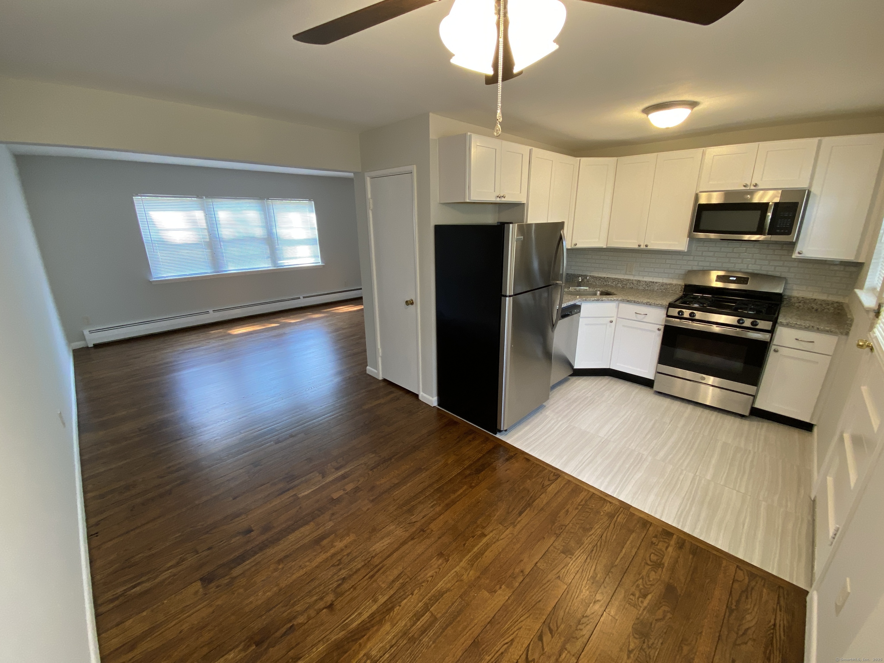 15 Elizabeth Street, Unit 31 West Haven, CT 06516 - Photo 3 of 9 a kitchen with stainless steel appliances a refrigerator stove microwave and cabinets