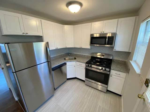 a kitchen with stainless steel appliances a refrigerator stove microwave and sink