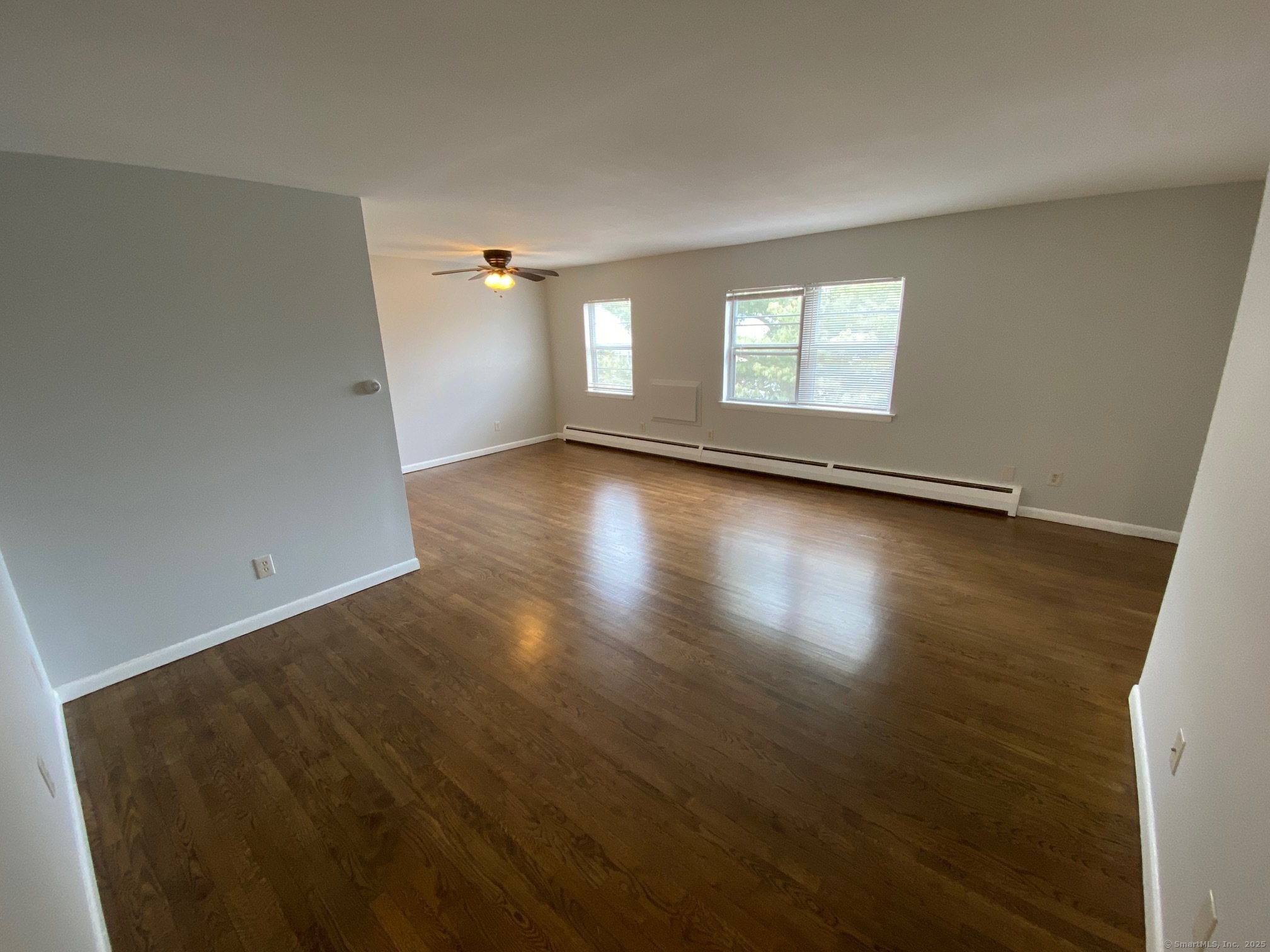 15 Elizabeth Street, Unit 31 West Haven, CT 06516 - Photo 5 of 9 an empty room with wooden floor and windows