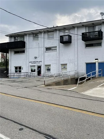 a view of living room kitchen with stainless steel appliances and cabinets