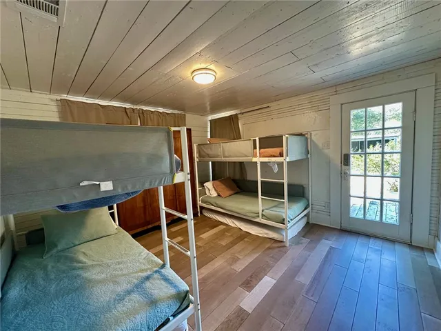 a view of a room with wooden floor and windows