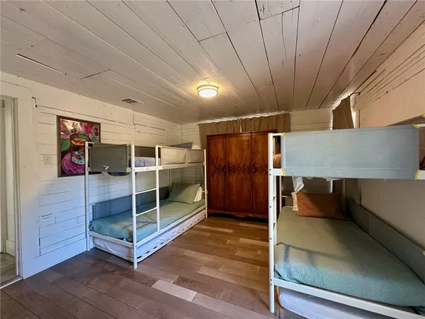 a room with wooden floor and windows