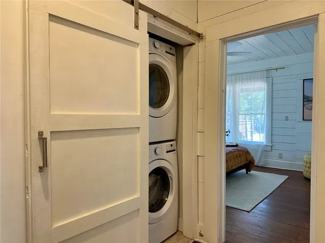 a room with wooden floor and windows
