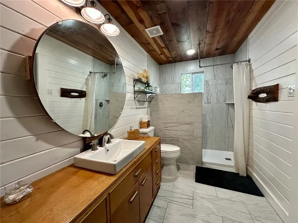 a spacious bedroom with a bed and a chandelier