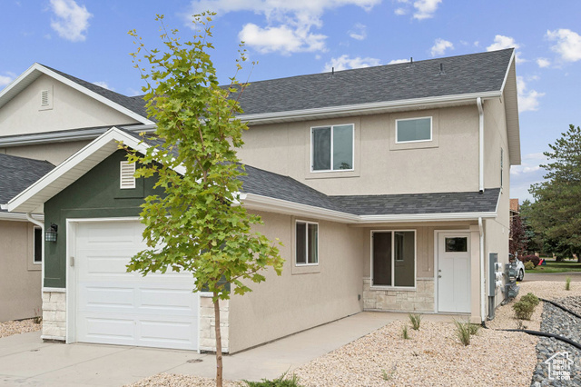 1615 North Angel Street, Unit I Layton, UT 84041 - Photo 2 of 56 Traditional home with stucco siding, a shingled roof, stone siding, and a garage