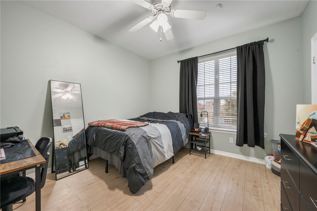 1198 Jones-Butler Road, Unit 2109 College Station, TX 77840 - Photo 12 of 16 a bedroom with a bed and a chandelier