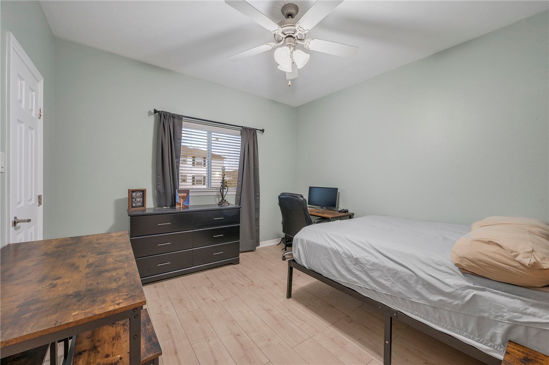 1198 Jones-Butler Road, Unit 2109 College Station, TX 77840 - Photo 14 of 16 a bedroom with a bed and a chandelier