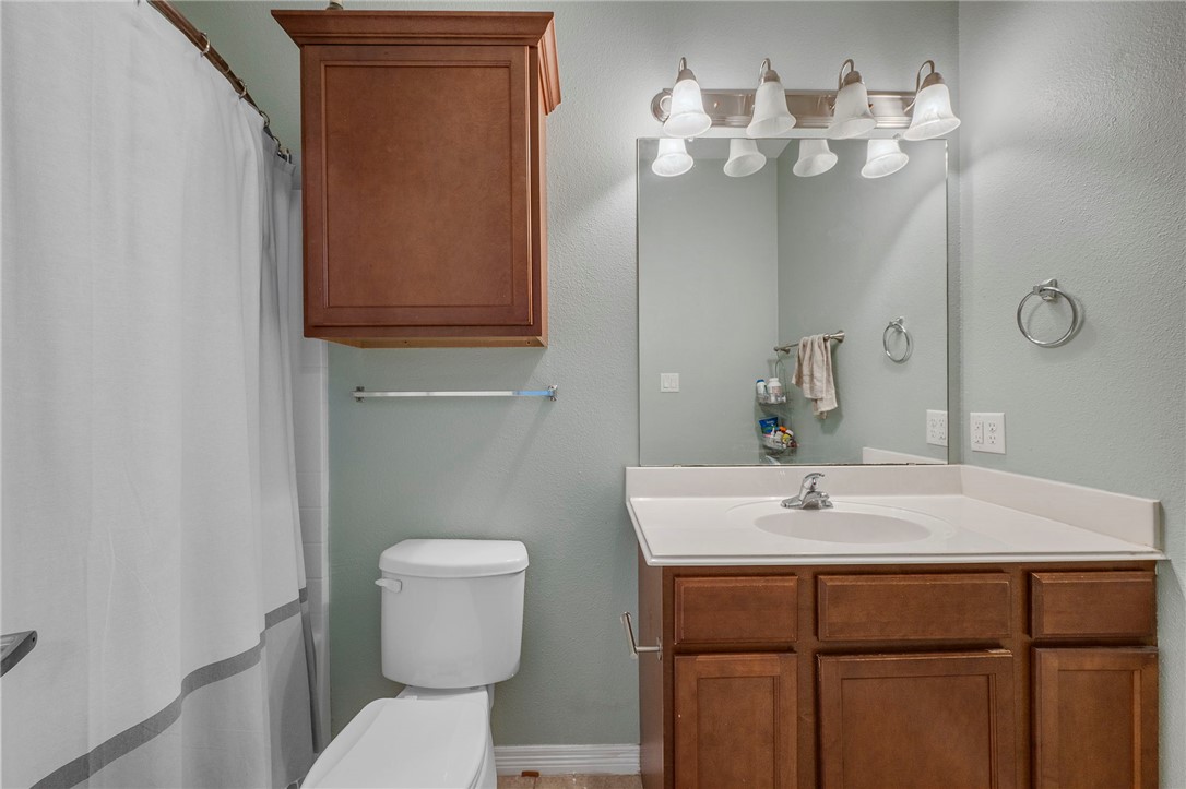 1198 Jones-Butler Road, Unit 2109 College Station, TX 77840 - Photo 15 of 16 a bathroom with a sink a toilet and mirror