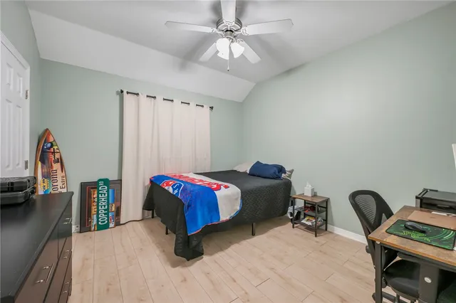 a bedroom with a bed and a desk