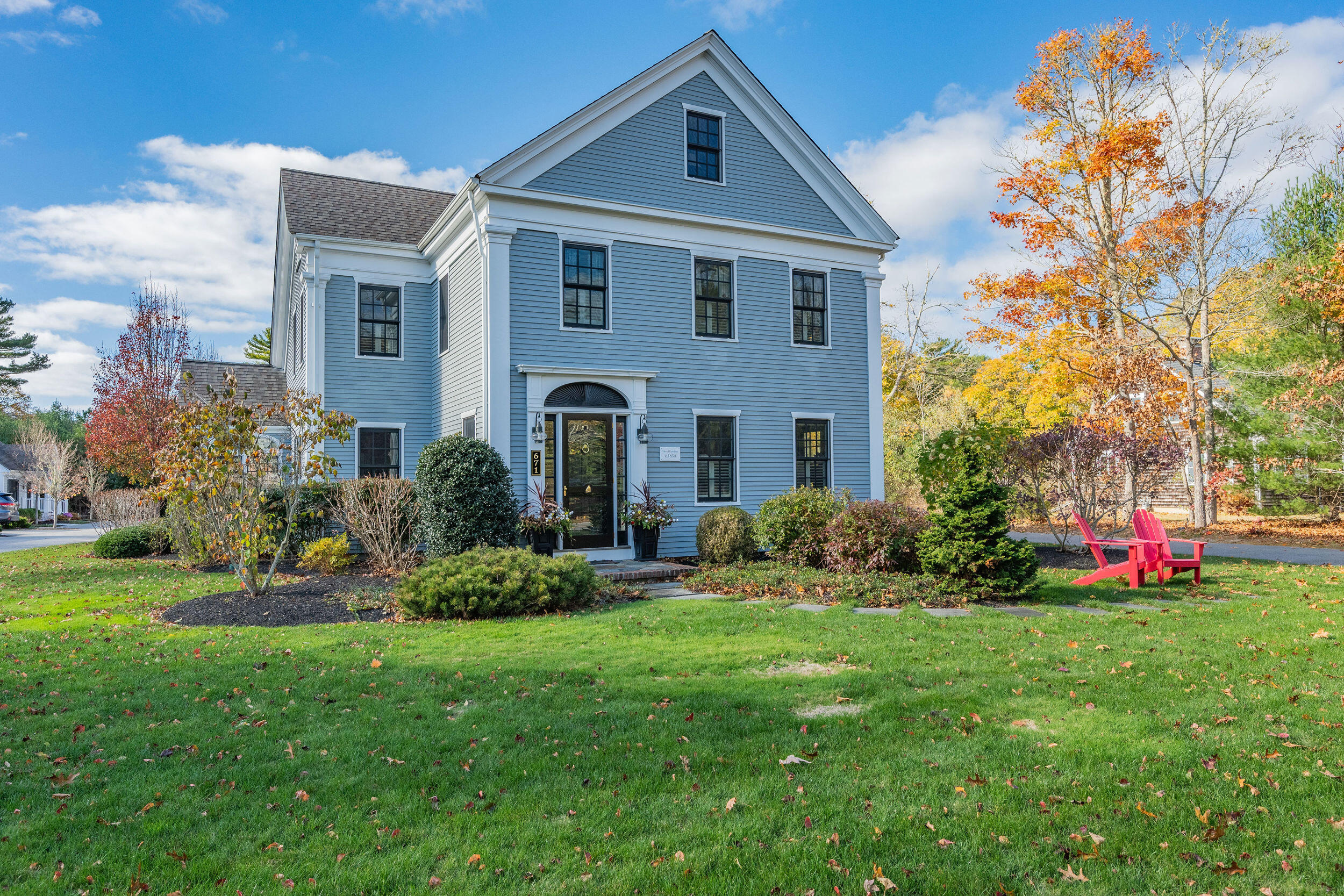 a front view of house with yard and green space