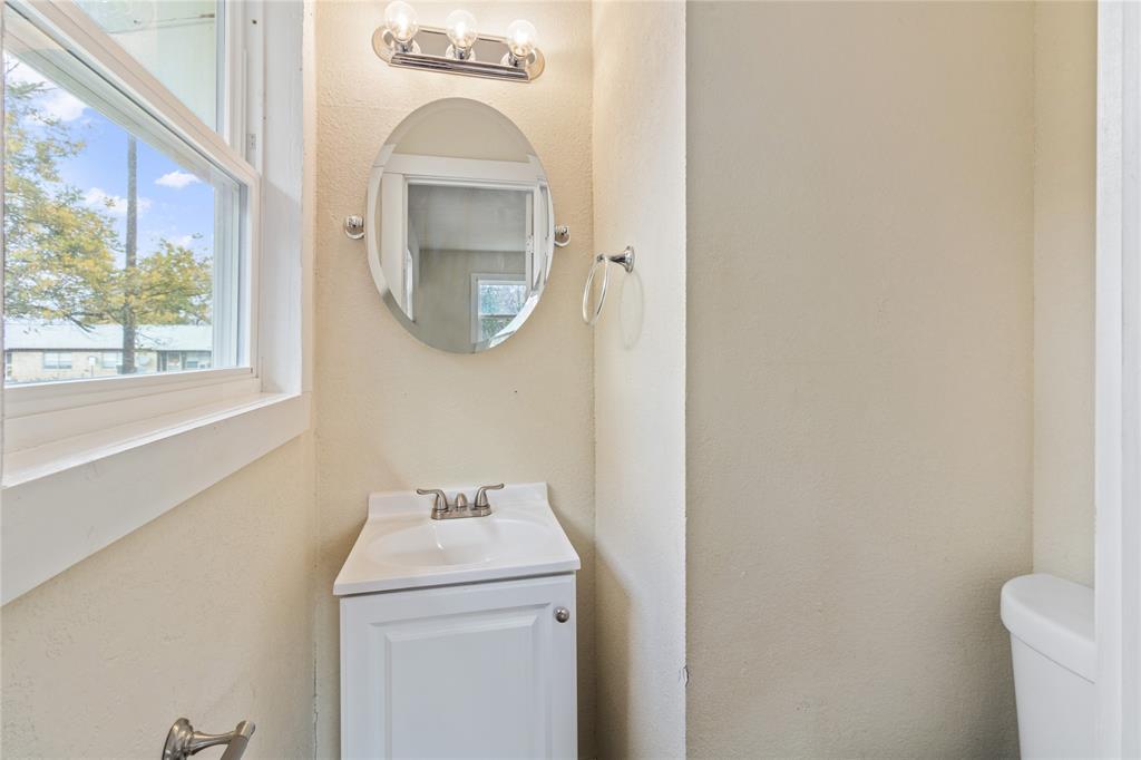 212 East 2nd Street Coleman, TX 76834 - Photo 13 of 17 a bathroom with a sink and a mirror
