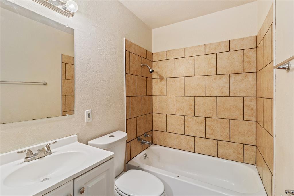 212 East 2nd Street Coleman, TX 76834 - Photo 14 of 17 a bathroom with a sink a toilet and shower
