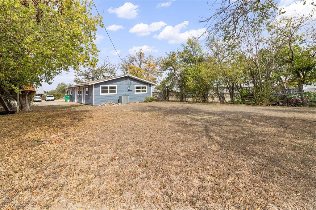 212 East 2nd Street Coleman, TX 76834 - Photo 15 of 17 a front view of a house with a yard and trees